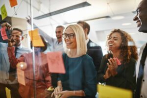 Adjuster Team Working to Offer Competitive Compensation Packages, Balance Caseloads, Create Clear Career Development Paths, and Foster a Supportive Culture and Leadership Style - 4 Strategies for Adjuster Retention in Workers’ Compensation Claims Management